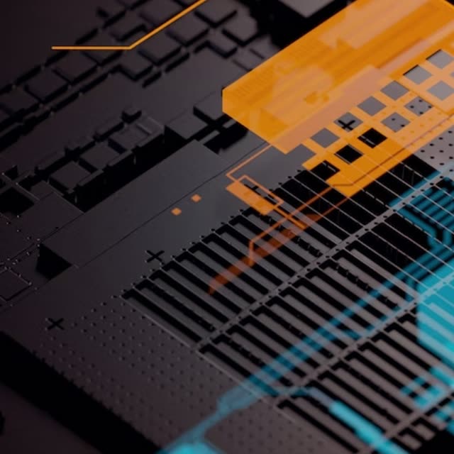 A close-up of a circuit board lit with orange and blue light.